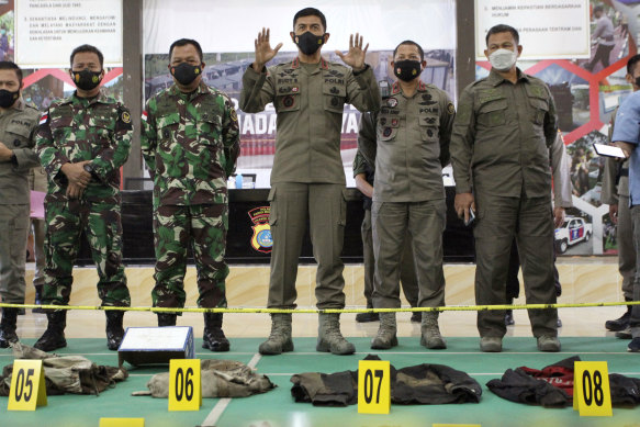 Central Sulawesi Police Chief Rudi Sufariadi, centre, speaks to the media as the items confiscated from Ali Kalora and Jaka Ramadan, two militants who were killed during shootout with security forces, are displayed.