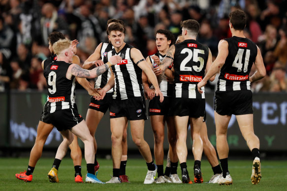 Josh Carmichael is congratulated by Magpies teammates after a goal.