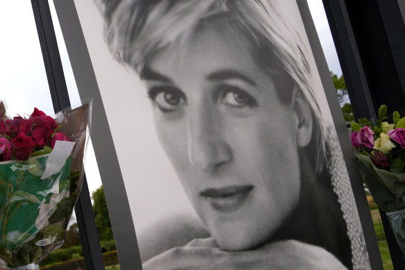 Flowers and a portrait of Princess Diana are displayed on the gates of Kensington Palace on Tuesday.
