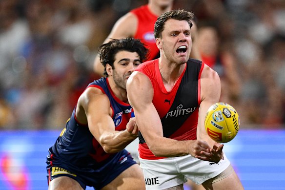 Jordan Ridley of the Bombers handballs.