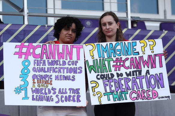 Fans of Canada holding signs in support of the current dispute regarding pay and conditions at the SheBelieves Cup in Florida.