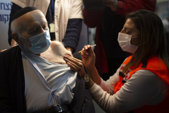 Joseph Zalman Kleinman, 92, a Holocaust survivor, receives his second dose of the Pfizer vaccine for COVID-19 at a sports arena in Jerusalem last month. 