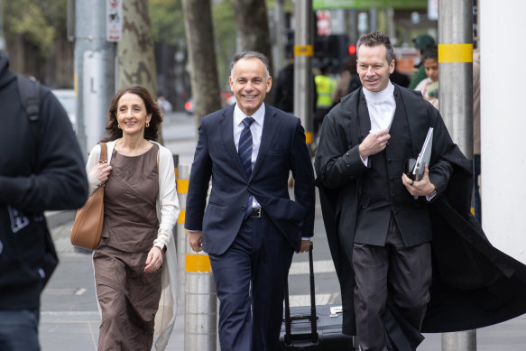 John Pesutto (centre), Dr Matt Collins (right) and Pesutto’s wife, Betty, arriving at the Federal Court earlier this morning.