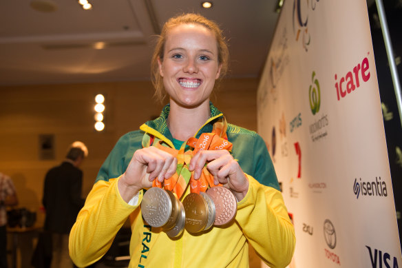 Ellie Cole displays her medals at a press conference at Sydney Airport after arriving back in Sydney from the Rio Paralympics.