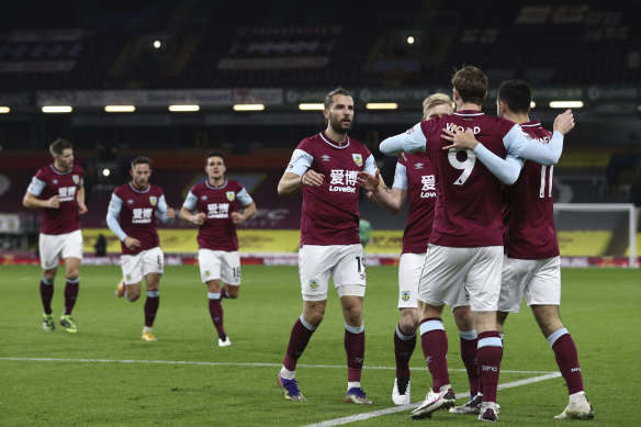 Chris Wood celebrates with teammates after scoring for Burnley.