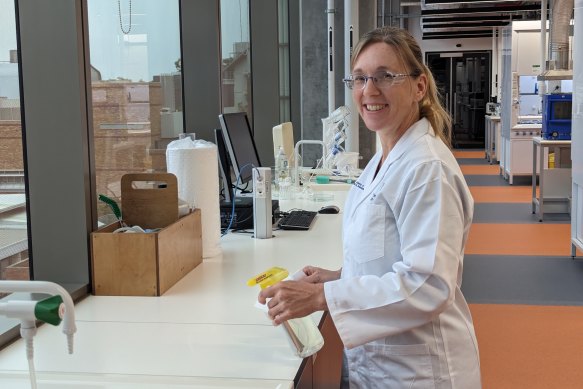 UQ researcher Dr Heather Shewin sprays down a bench with their newly developed anti-viral spray.