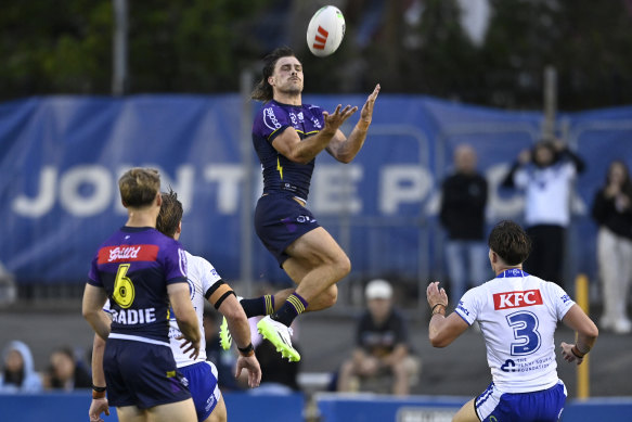 Ryan Papenhuyzen leaps high for the ball.