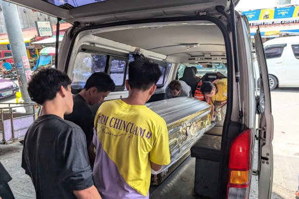 The body of Lucita Barquin Cortez being loaded into a funeral home van on Friday. 