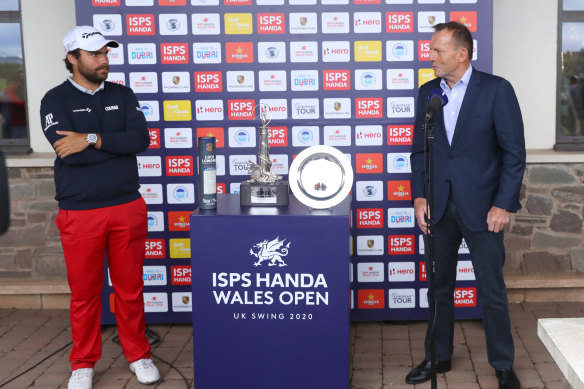 Former Australian prime minister Tony Abbott (right) presents the Wales Open trophy to Romain Langasque, of France in Newport, Wales, in August.