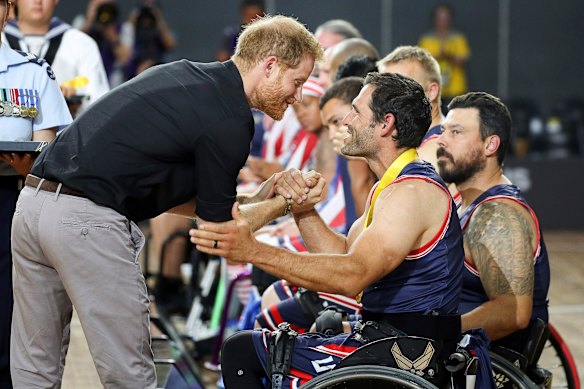 Britain’s Prince Harry congratulates a member of the United Kingdom Invictus Games team. 