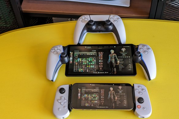 The PlayStation Portal (centre), with a standard DualSense controller and an iPhone in a Backbone One mount.