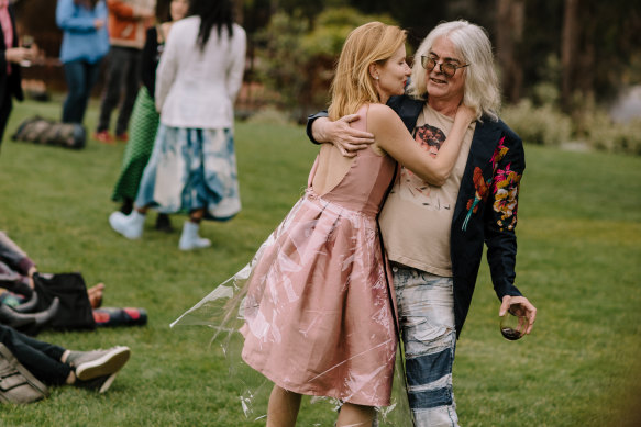 With husband David Walsh. They met in a beer garden at Art Basel in 2007.