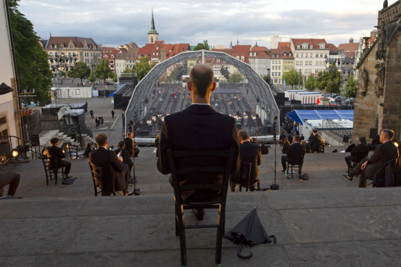 Singers sit apart for a rehearsal of the Cathedral Steps open air festival in front of Mariendom (Cathedral of Mary) and St Severi's Church in Erfurt, Germany, last week.