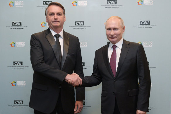 Russian President Vladimir Putin, right, and Brazil’s then-president Jair Bolsonaro shake hands at the BRICS summit in Brazil in 2019.