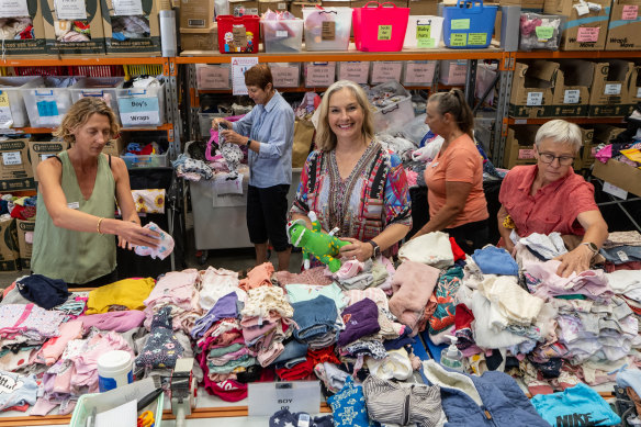 Voss with volunteers sorting donated items at Big Group Hug.