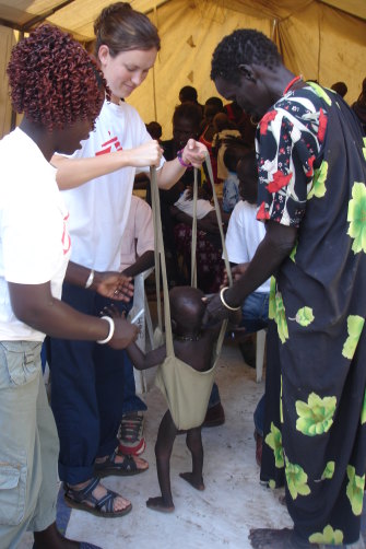 Kent weighs a young child ahead of admission. Children are regularly admitted for malnutrition.