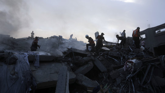 Palestinians look for survivors under rubble.