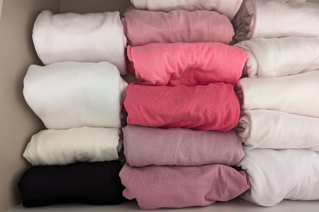 Clothes drawer with neatly folded shirts using Marie Kondo's file folding method.