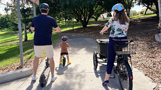 Charlie and Ben Cole get around Brisbane car-free and run the charliehateshiscarseat account on Instagram. Pictured with journalist Felicity Caldwell.