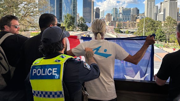 The 52-year-old man at the Brisbane rally was detained but not arrested, allegedly for breaching the peace.