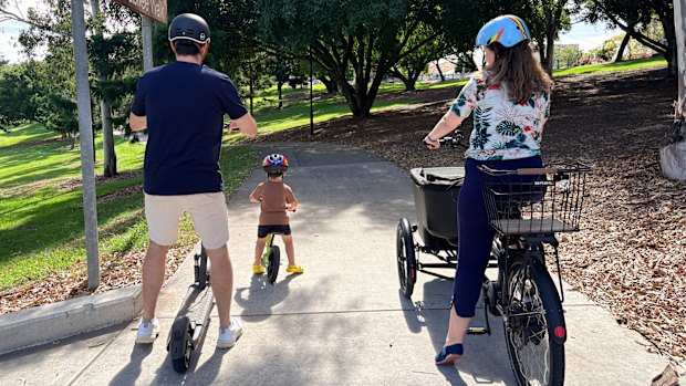 Charlie and Ben Cole get around Brisbane car-free and run the charliehateshiscarseat account on Instagram. Pictured with journalist Felicity Caldwell.