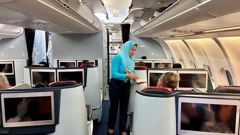 Travel writers describe dated business-class service on a non-stop flight to an island destination