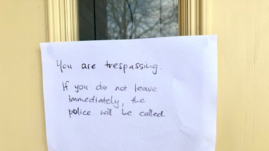 A sign threatening to call the police outside of home of Erin Patterson’s sister.
