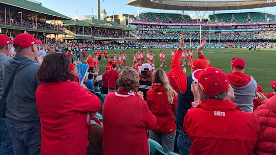 Swans players are cheered as they walk off at half-time.