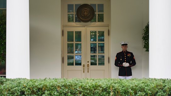 A U.S. Marine stands outside the entrance to the West Wing of the White House as President Donald Trump meets in the Situation Room, Tuesday, June 17, 2025, in Washington. (AP Photo/Evan Vucci)