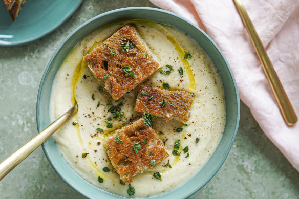 This creamy cauliflower and potato soup is topped with mini cheese toastie bites and drizzled with olive oil (see below).