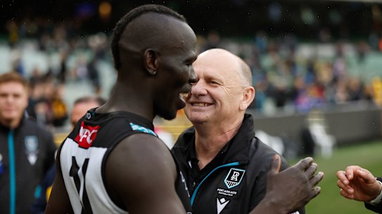 Power defender Aliir Aliir celebrates victory with coach Ken Hinkley.