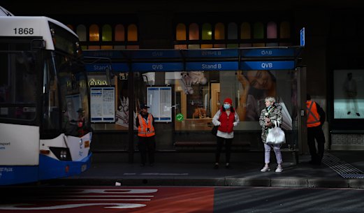 Commuters in Sydney on Tuesday morning wait for buses outside QVB.