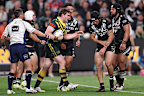 Kalyn Ponga of New Zealand holds his arm.