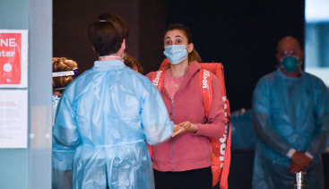 A quarantine worker and tennis players at the Grand Hyatt hotel in Melbourne on January 21.
