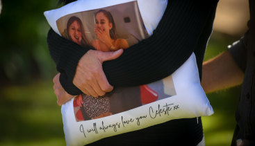 Celeste Manno's mother, Aggie Di Mauro, clutches a pillow with a photo of her daughter.