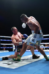 Justis Huni knocks Paul Gallen to the canvas.