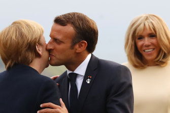 Kiss it good-bye, say some French.  French President Emmanuel Macron, kisses German Chancellor Angela Merkel, while his wife Brigitte looks on in 2019.