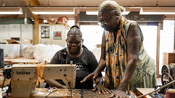Tiwi Islands woman Lucia Pilakui, who has been involved with Bima Wear for 50 years, training Tamsin Kantilla.