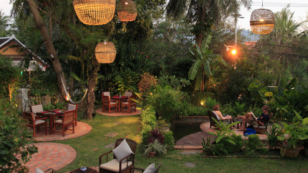 Dine under a canopy of trees and hanging lanterns at 3 Nagas.
