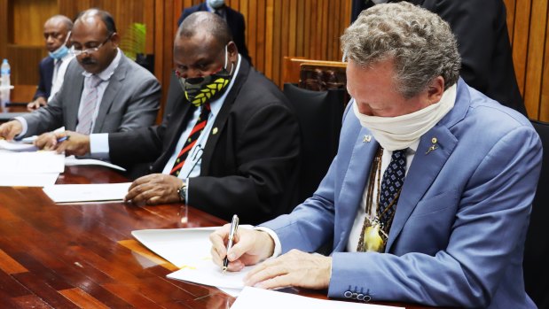 PNG Prime Minister James Marape and Andrew 'Twiggy' Forrest signing an agreement in Port Morseby.