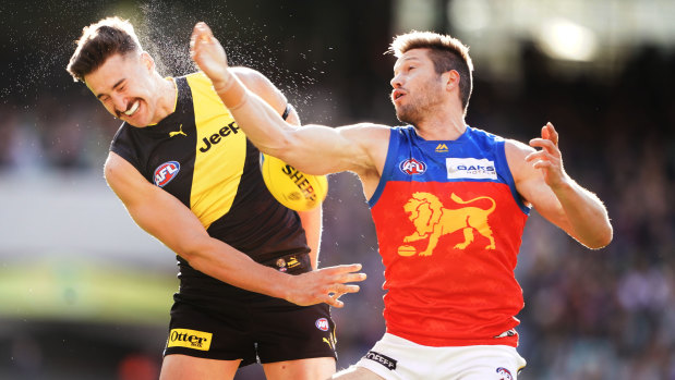 Copping a spray: Ivan Soldo sweats it out for Richmond against Brisbane's Stefan Martin.