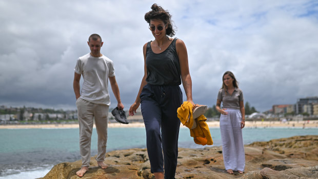 Backpackers Yaroslav Havrysh, Lena Zaim and Natasha Hastings, pictured at Bondi Beach, remain enthusiastic about their travel experiences in Australia despite the COVID-19 crisis.