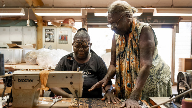 Tiwi Islands woman Lucia Pilakui, who has been involved with Bima Wear for 50 years, training Tamsin Kantilla.