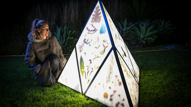 Melbourne artist Kathy Holowko in front of her one of her lanterns showcasing the work of the herbarium. 