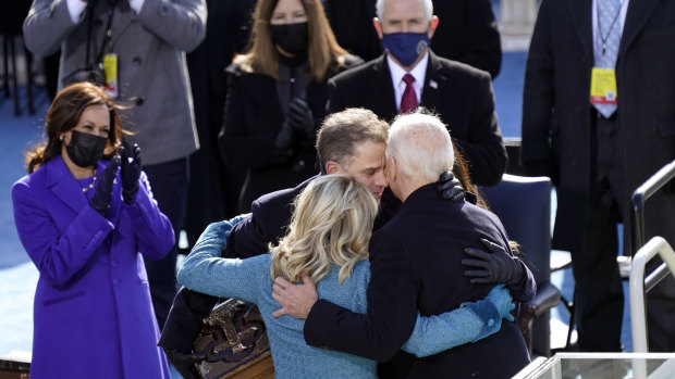 Joe Biden hugs first lady Jill Biden,  son Hunter and daughter Ashley after his swearing-in as Kamala Harris looks on. 