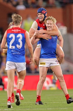 Clayton Oliver celebrates kicking a goal.