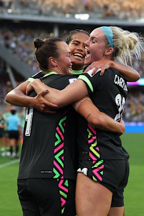 Caitlin Foord, Mary Fowler and Ellie Carpenter soak up the moment.