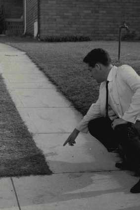 Investigator points to footprints believed to belong to the Kingsgrove Slasher, February 18, 1959.