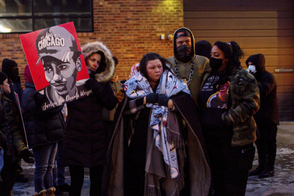 Katie Bryant, Daunte Wright’s mother, is surrounded by community members and activists.