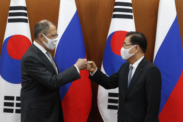 South Korean Foreign Minister Chung Eui-yong (R) bumps elbows with Russian Foreign Minister Sergei Lavrov after a joint announcement at the Foreign Ministry on March 25, 2021 in Seoul, South Korea.